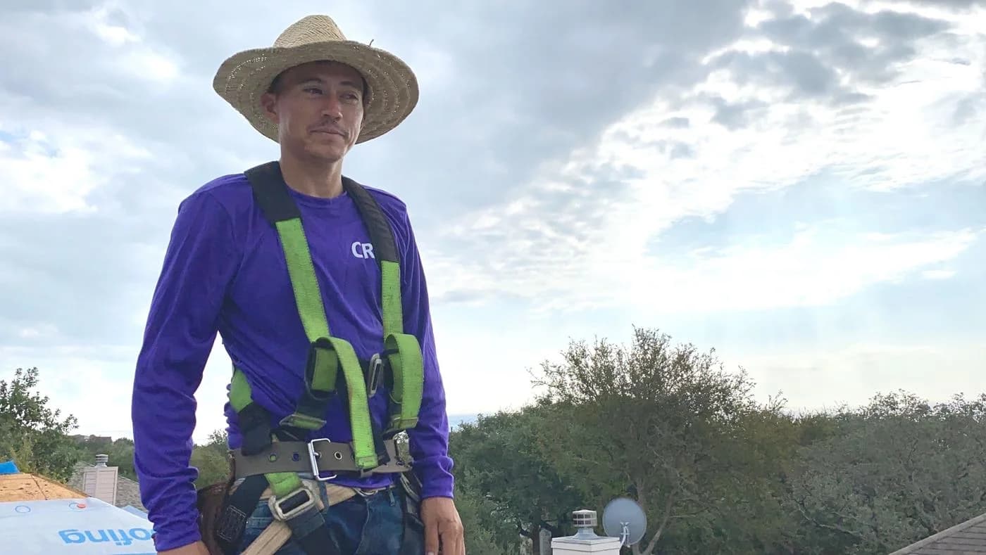 A Mammoth roofer in a safety harness on a job site