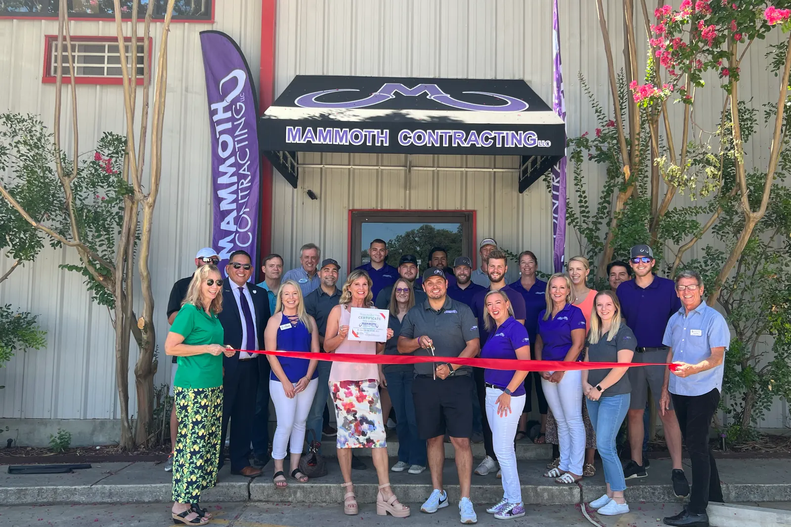 The Mammoth team and guests at the ribbon cutting under the Mammoth Contracting awning of the Boerne office