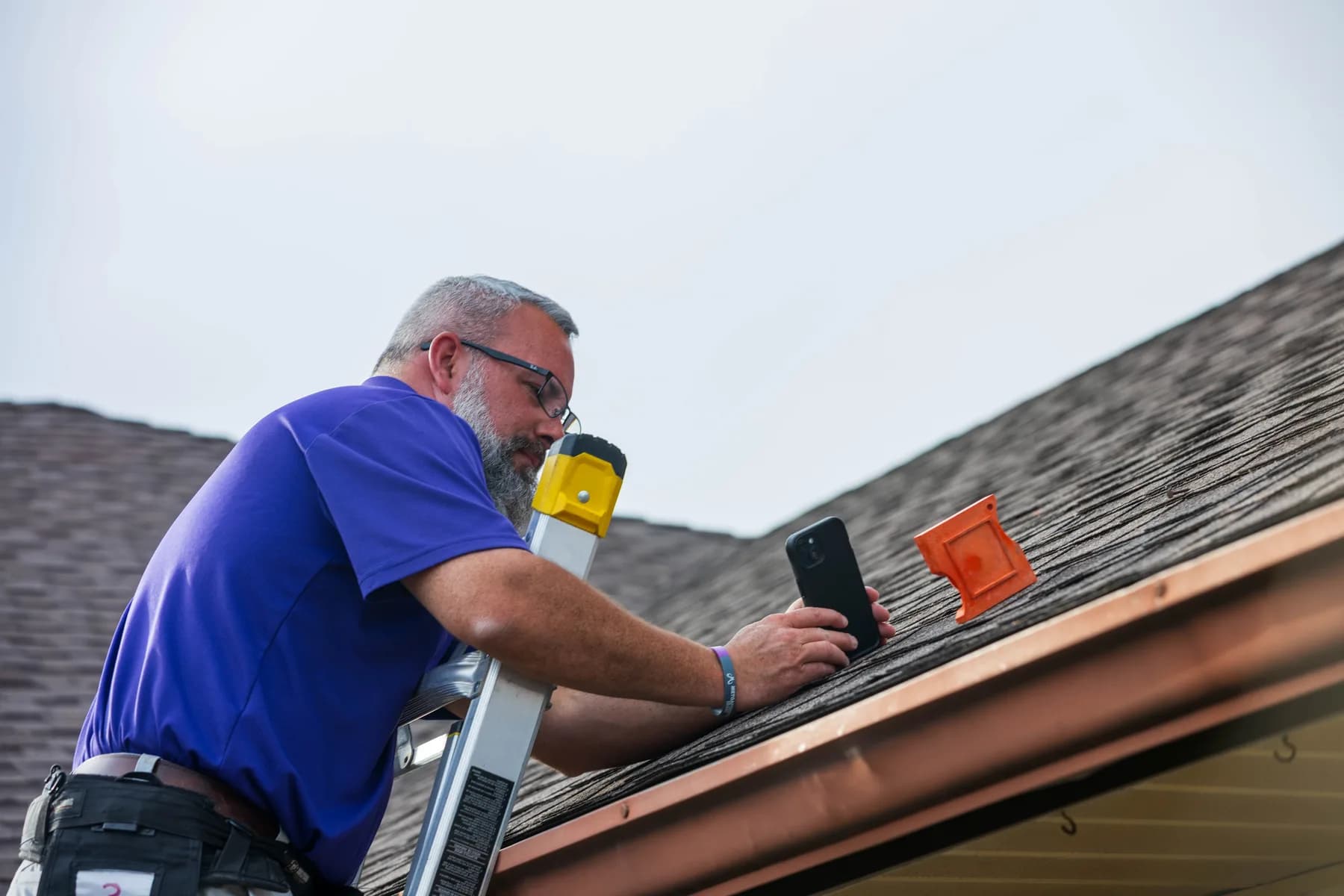 A Mammoth inspector photographing a roof edge