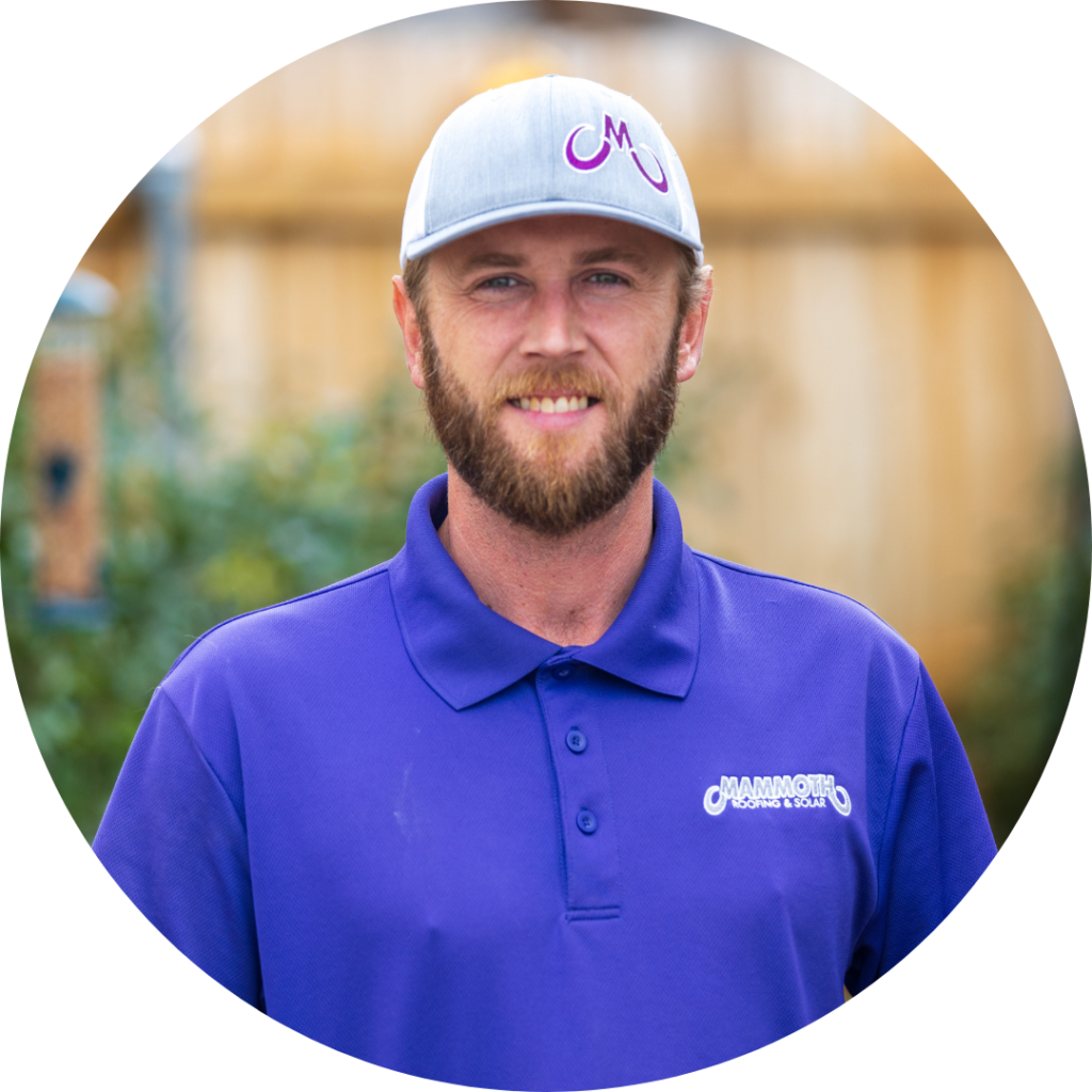 Aaron Massey - Roofing Specialist at Mammoth Roofing & Solar, wearing a purple polo and gray company cap, smiling in an outdoor setting.