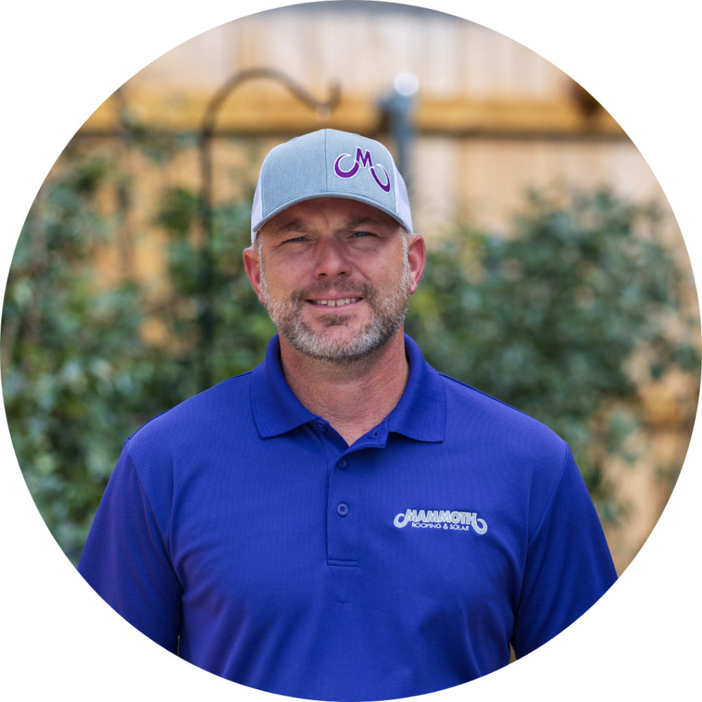 DJ Adams, a roofing specialist at Mammoth Roofing & Solar, wearing a branded company polo and cap in an outdoor setting.