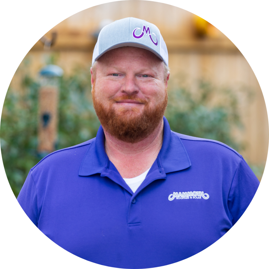 James Frei - Roofing Specialist at Mammoth Roofing & Solar, wearing a purple polo and gray company cap, smiling in an outdoor setting.