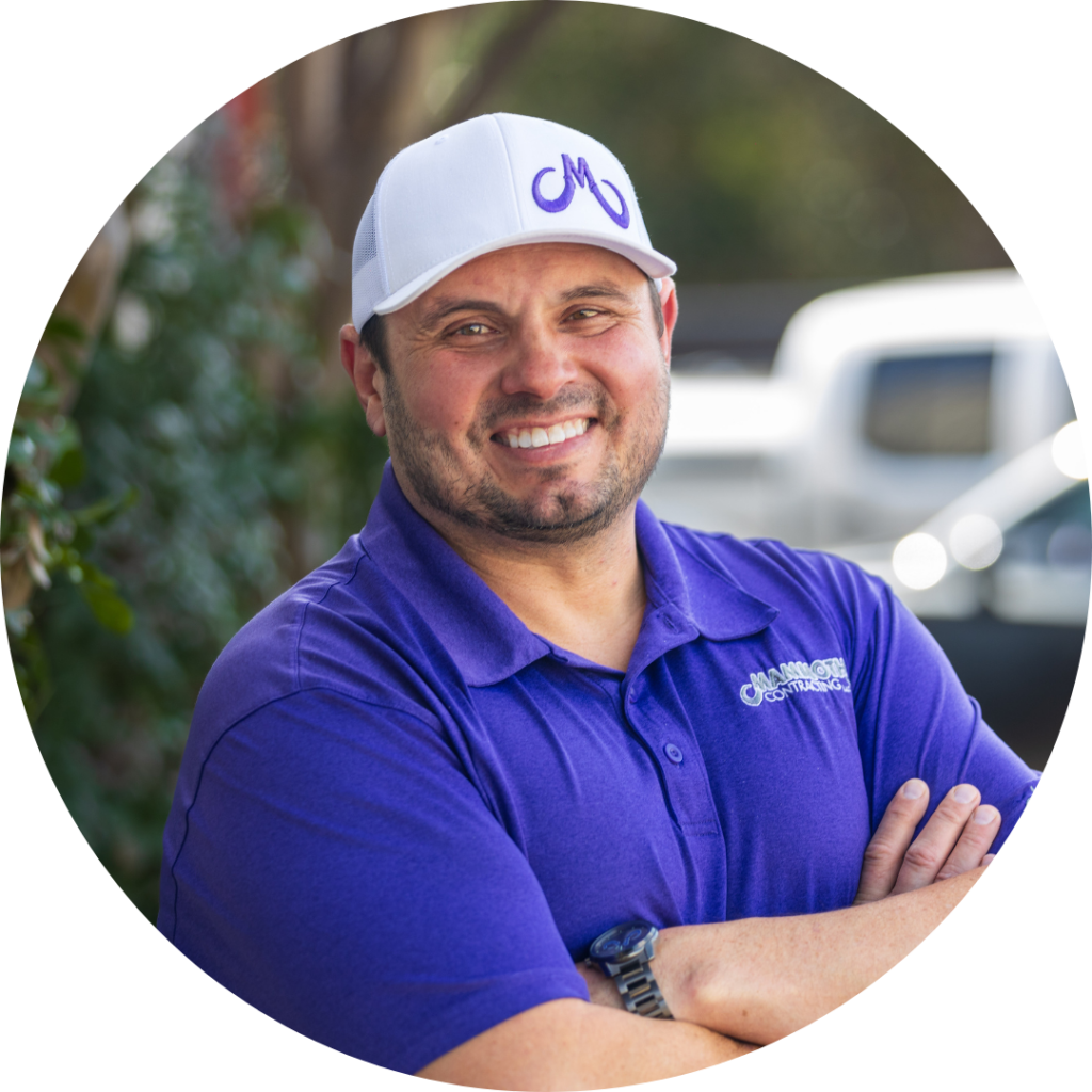 Scott Edwards - Roofing Specialist at Mammoth Roofing & Solar, wearing a purple polo and white company cap, smiling outdoors.