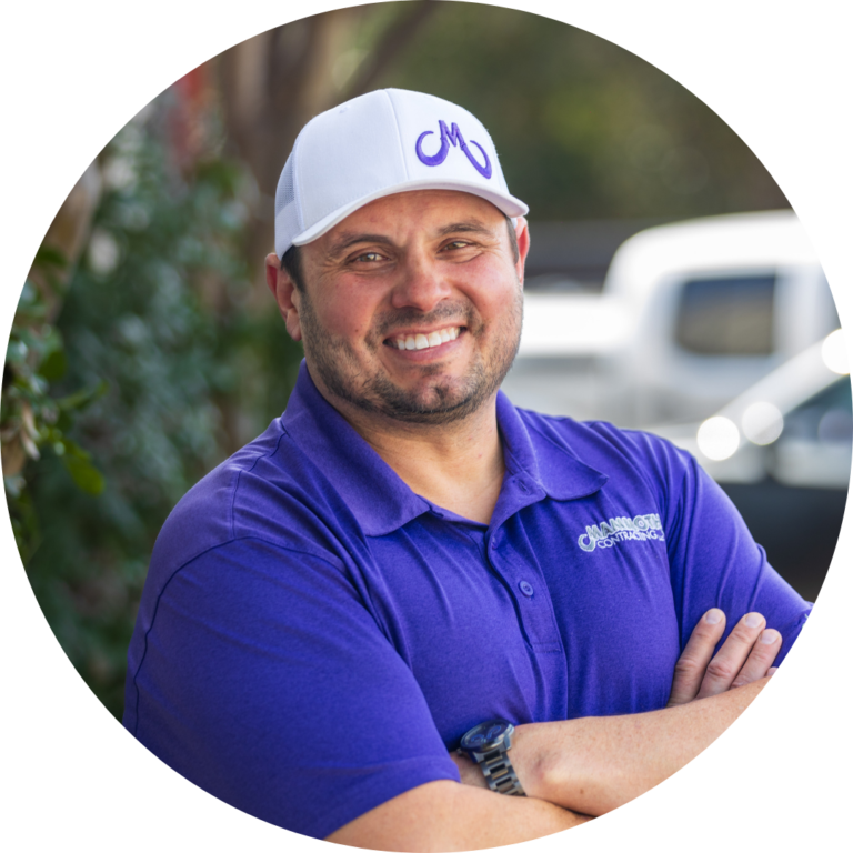 Scott Edwards - Roofing Specialist at Mammoth Roofing & Solar, wearing a purple polo and white company cap, smiling outdoors.